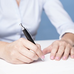 AMG_IMG_Woman signing document on the table
